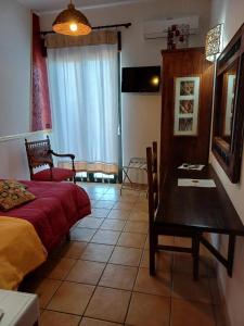 a bedroom with a bed and a table and a desk at Terre del Sud in Locri