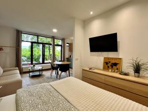 a bedroom with a bed and a flat screen tv at NOAR Enjoy Your Stay in Orešje