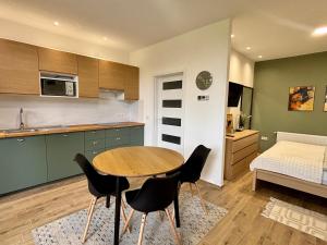 a kitchen with a table and chairs in a room at NOAR Enjoy Your Stay in Orešje