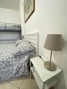 a bedroom with a bed and a lamp on a nightstand at Renaio House Buti in Bientina