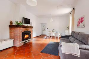 a living room with a couch and a fireplace at Fuga nel Parco Trebbia, vicino Grazzano/Bobbio in Rivergaro