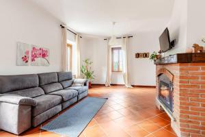 a living room with a couch and a fireplace at Fuga nel Parco Trebbia, vicino Grazzano/Bobbio in Rivergaro +19 photos
