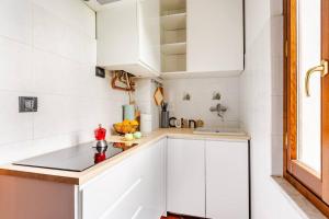 a kitchen with white cabinets and a sink at Fuga nel Parco Trebbia, vicino Grazzano/Bobbio in Rivergaro