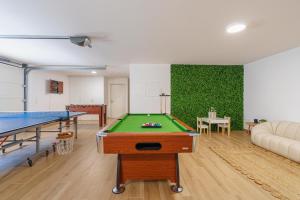 a room with a pool table and ping pong tables at Paradise Villa Sea - Signature by Paradise Portugal in Ribamar