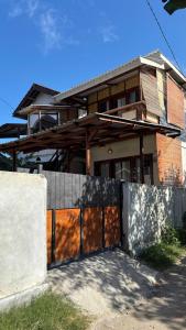 a house with a fence in front of it at Villa Nacita in Bumbang