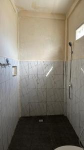 a bathroom with a shower and a toilet at Villa Nacita in Bumbang +1 photo