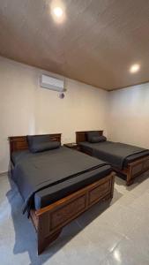 two twin beds in a room with at Villa Nacita in Bumbang