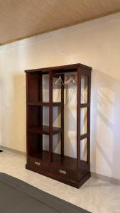a wooden cabinet with glass shelves in a room at Villa Nacita in Bumbang