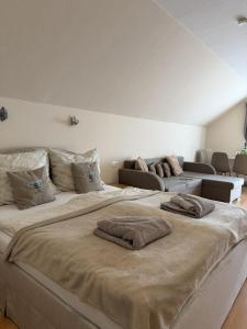a bedroom with two beds with pillows on them at Akácfa B&B in Zalakaros +50 photos