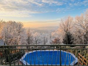 a swimming pool on a balcony with snow covered trees at Villa Bellevue in Mailly-le-Château