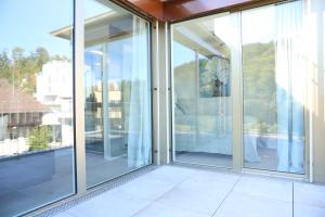 an empty room with sliding glass doors on a balcony at Lamira Serviced Apartments Zurich City in Zurich