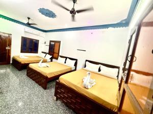 a hotel room with two beds with towels on them at natchiyar home stay in Rāmeswaram +2 photos