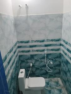 a bathroom with a toilet and a shower at natchiyar home stay in Rāmeswaram