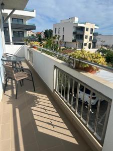 a balcony with two chairs and a table on a building at Guest House Ana in Zadar