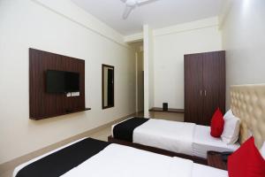 a hotel room with two beds and a flat screen tv at Triple Tree Hotels and Resorts in Bhubaneshwar