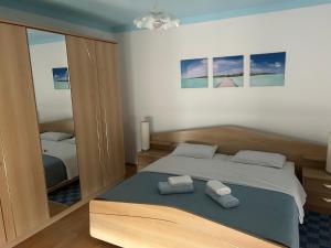a bedroom with a bed with two towels on it at Guest House Ana in Zadar