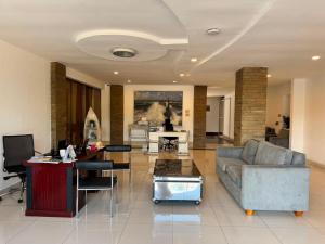 a living room with a couch and a table at Eldon Hotel & Apartments in Nairobi