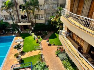an apartment building with a courtyard with a swimming pool at Eldon Hotel & Apartments in Nairobi