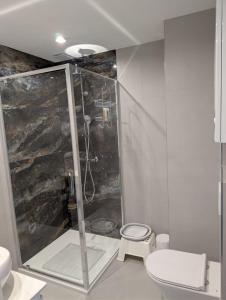 a bathroom with a shower and a toilet at Apartament Las in Żagań