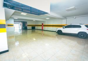 a white car parked in a parking garage at Mandala Medellín Belén By GyC Hotels in Medellín