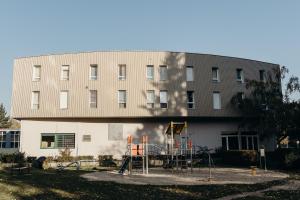 a building with a playground in front of a building at Smarthotel Nezvalova Archa in Olomouc