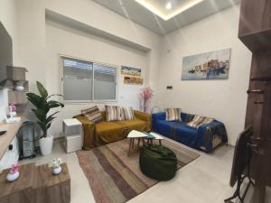 a living room with two couches and a table at Front beach cosy apartment in La Goulette