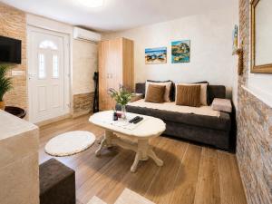 a living room with a couch and a table at Apartments Obradovic in Krašići