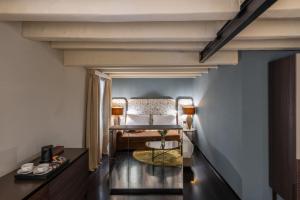 a room with a bed and a table at Palazzo Rota Luxury Apartments in Venice