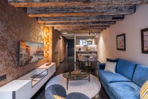 a living room with a blue couch and a table at Palazzo Rota Luxury Apartments in Venice