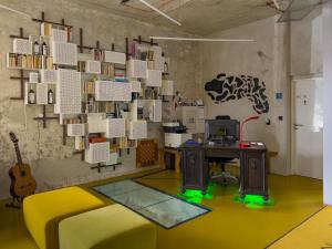 a room with a desk and a wall of books at Smarthotel Nezvalova Archa in Olomouc