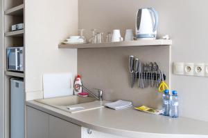 a kitchen counter with a sink and utensils at Smarthotel Nezvalova Archa in Olomouc