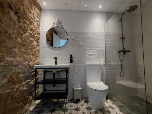 a bathroom with a toilet and a sink and a shower at Hotel Rural Casa Cuartel in San Vicente de Alcántara +37 photos