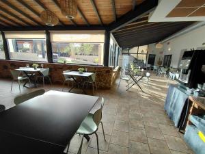 a restaurant with tables and chairs in a room at Hotel Rural Casa Cuartel in San Vicente de Alcántara