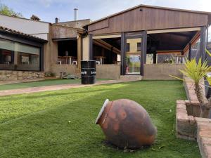 a football statue sitting on the grass in front of a building at Hotel Rural Casa Cuartel in San Vicente de Alcántara