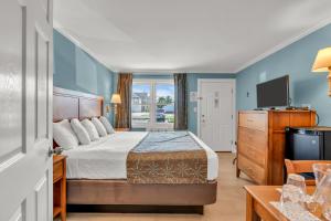 a hotel room with a bed and a television at Surfside Motel in Point Pleasant Beach +105 photos