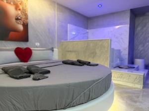 a bedroom with a bed with a heart on the wall at B&B Luxury Room e Spa in Apricena +41 photos
