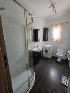 a bathroom with a shower and a toilet and a sink at Vendome in Paceville