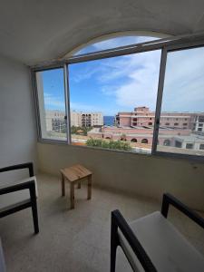 a room with a view of a city from a window at Vendome in Paceville +3 photos
