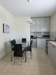 a kitchen with a dining room table and chairs at Vendome in Paceville