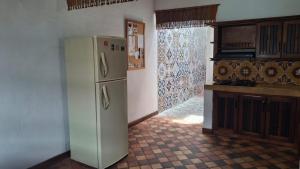a kitchen with a white refrigerator in a room at Casa Republicana en Jericó in Jericó