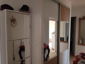 a room with glass cabinets and a mirror at Claloc portes d'azur in Bandol