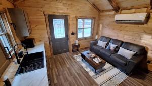 an overhead view of a living room with a leather couch at Micham's Clark Fork River Retreat - River Front, Mountain View, Fire Pit - Cabin 1 in Superior