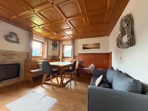 a living room with a couch and a table at Alphüsli Garfrescha in Sankt Gallenkirch