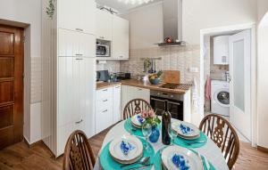 a kitchen with a table and chairs in a kitchen at Apartment Avelina in Mošćenice