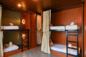 a room with three bunk beds in it at Layag La Union in san juan la union