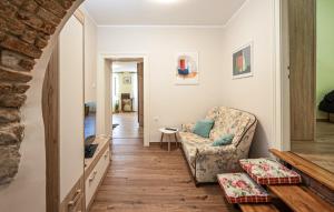a living room with a couch and a chair at Apartment Avelina in Mošćenice