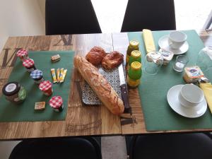 a table with bread and food on top of it at Le Clos des Elfes - suite climatisée in La Roque-Gageac +8 photos