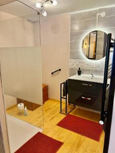 a bathroom with a sink and a mirror at Maison d'Hôtes Ty Belle in Saint-Guen