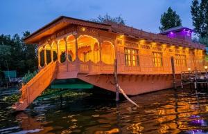 a house boat on the water at night at The Martin's Houseboat in Srinagar