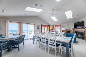 a dining room with a table and chairs at Pelican Watch - Kitty Hawk MP 3, 16 Yards to Beach, Ocean View, Pool, Hot Tub, Pool Table, Flex Stays in Kitty Hawk